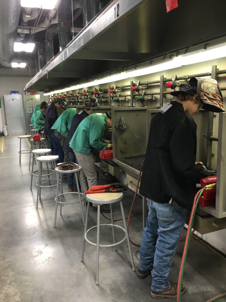 Students welding in the shop