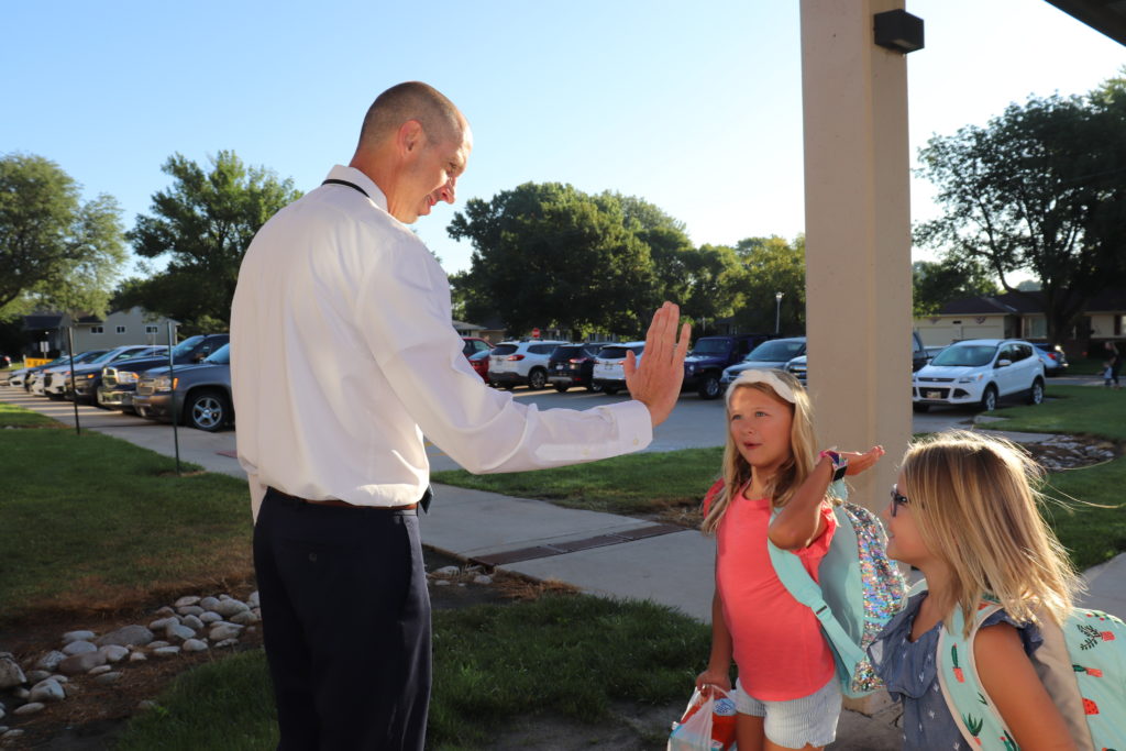 Jason Chicoine Clarmar Principal high fives students